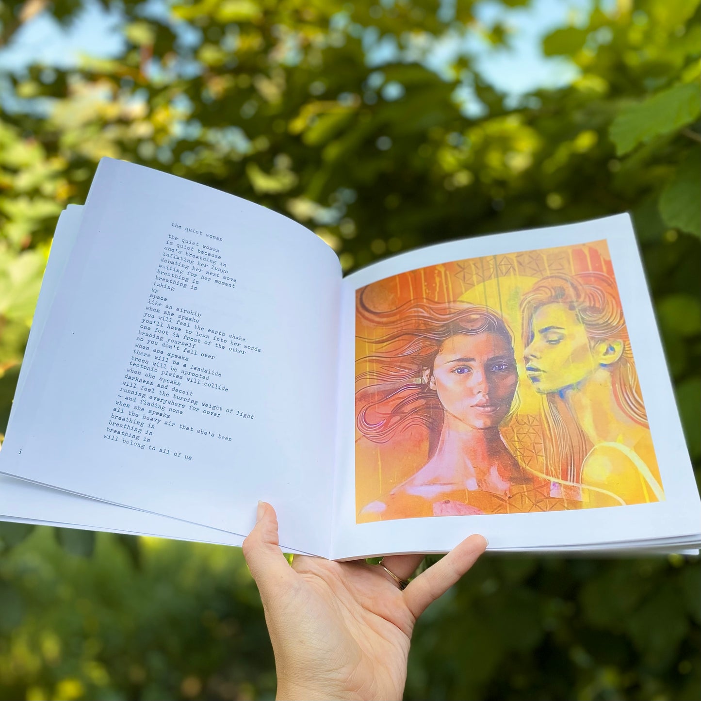 woman's hand holding The Quiet Woman book open on a page showing the poem The Quiet Woman alongside the accompanying painting