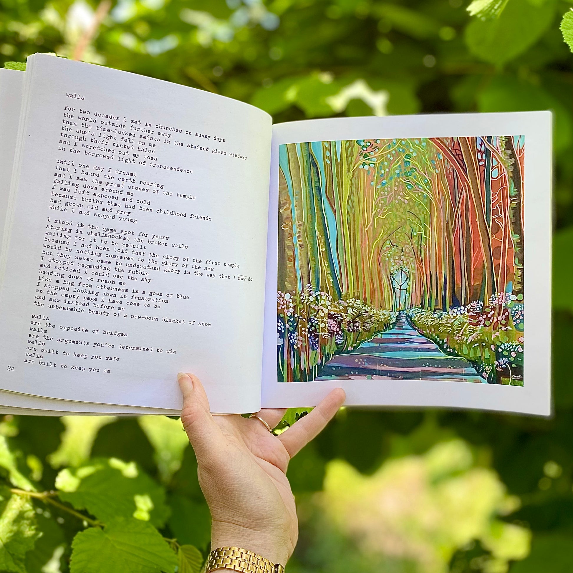 woman's hand holding The Quiet Woman book, open on a page showing the poem Walls and the accompanying painting