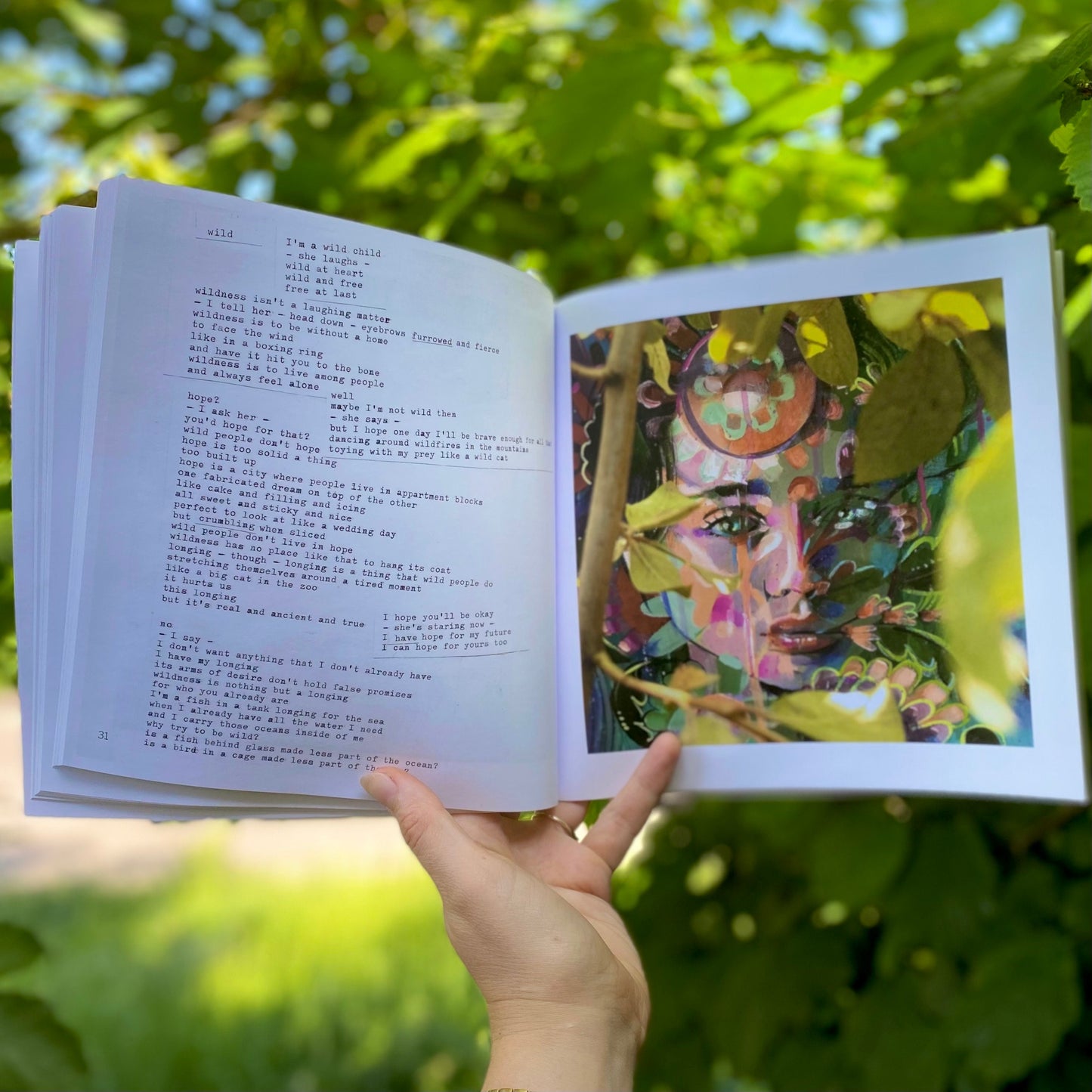 woman's hand holding The Quiet Woman book open on a page showing the poem Wild alongside the accompanying painting